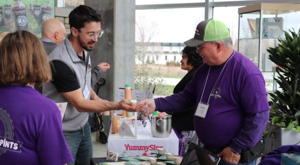 Business owner talks to potential buyers for food product at Meet the Buyer event