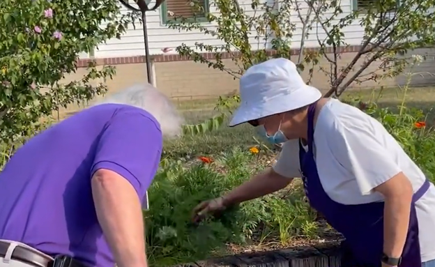Johnson County EMG working with resident at Evergreen Community