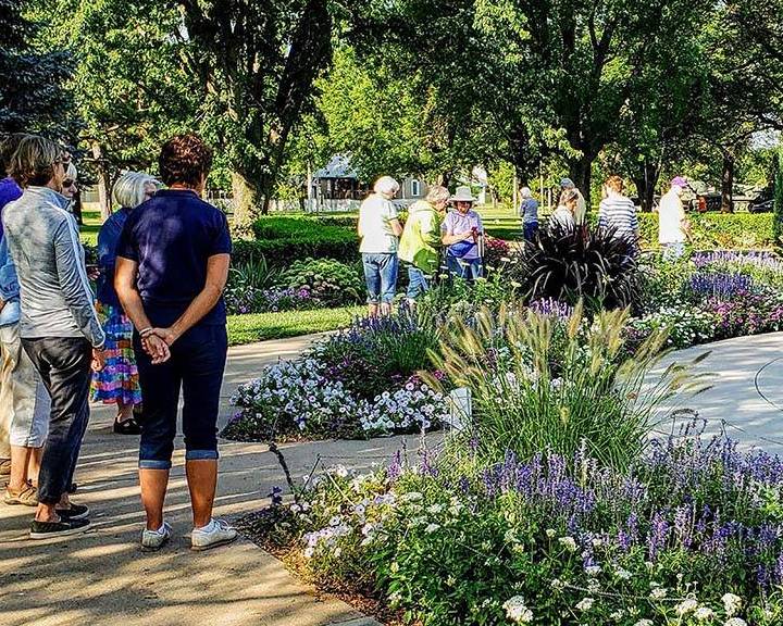 People exploring a garden at a garden tour held by Central Kansas District Extension Master Gardeners