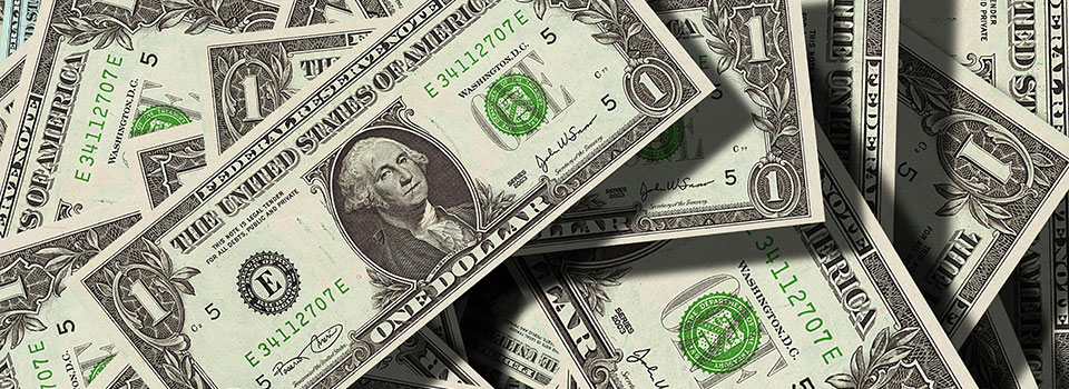 Closeup of dollar bills spread on a table