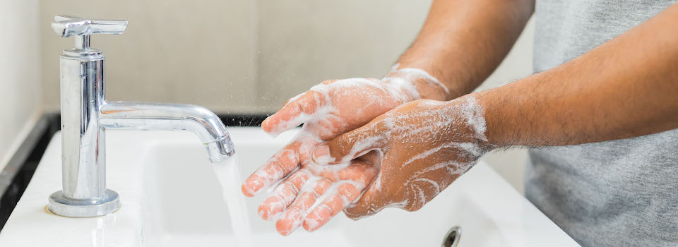 Person washing their hands.