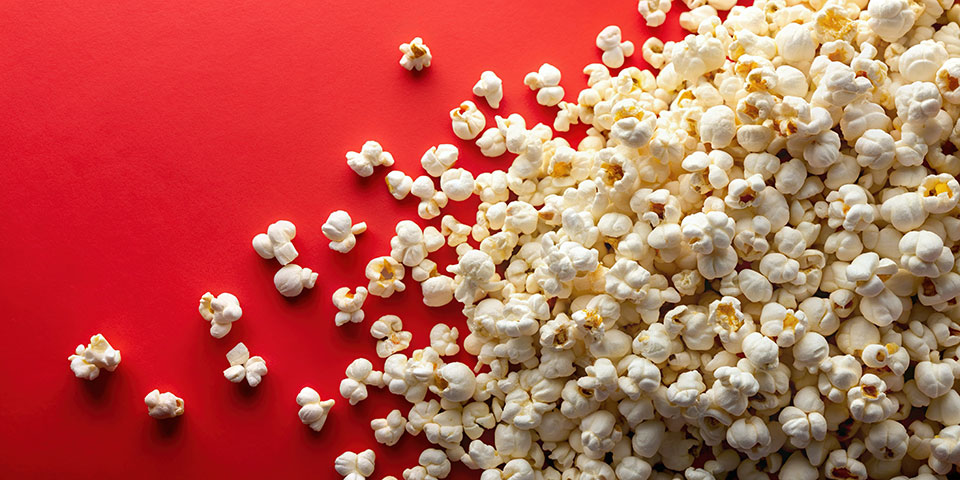 kernels of popcorn on a red background