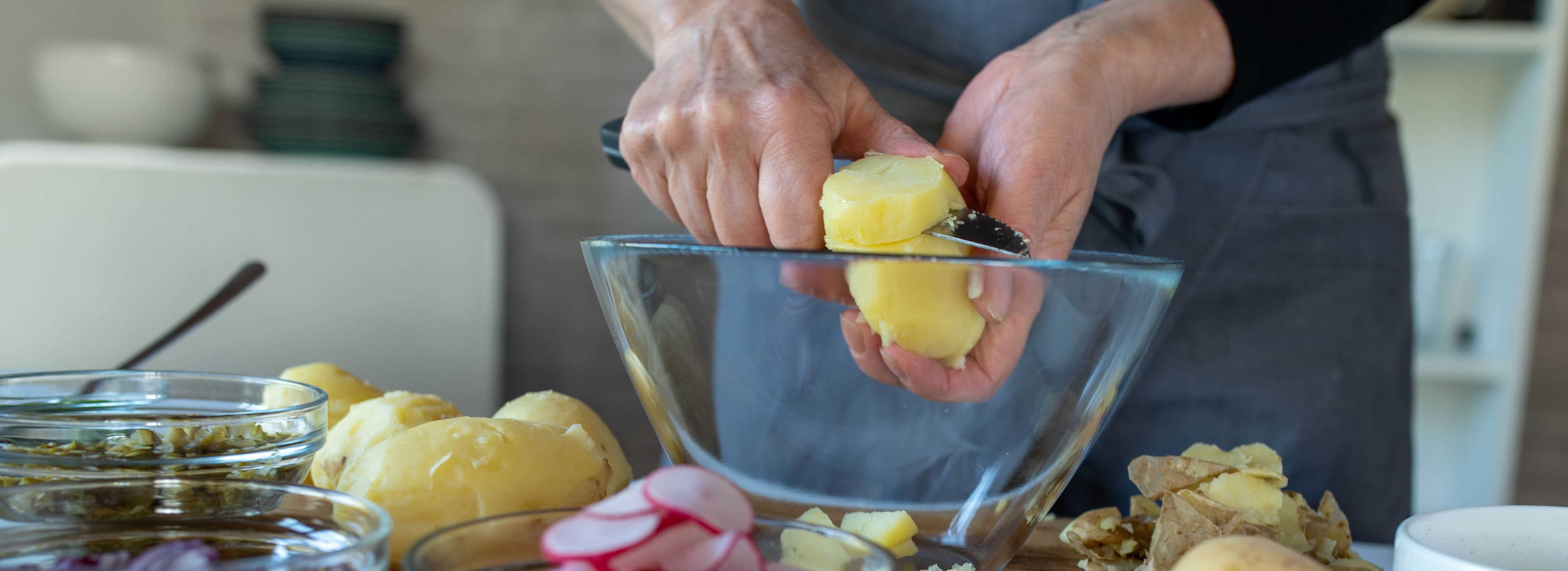 Woman cutting up potatoes.