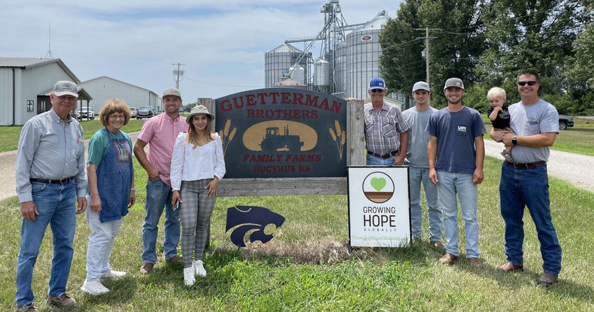 Family of Paul and Rosie Guetterman standing near farm sign Family of Paul and Rosie Guetterman standing near farm sign