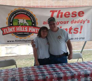 Karen and Darrin Moege, standing behind red-checkered table