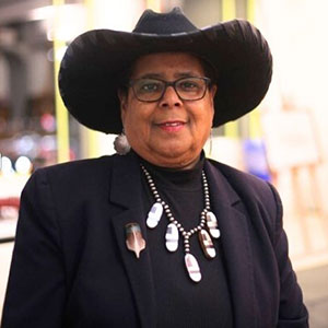 Portait, woman wearing black suit and black hat