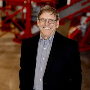 portrait of man in dark suit and eyeglasses