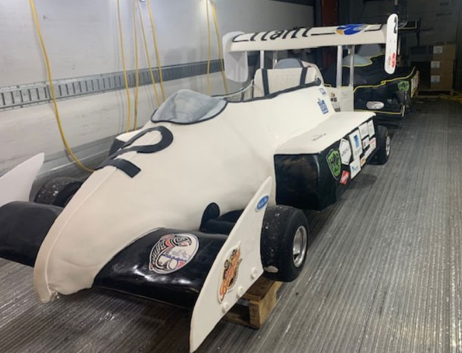 side view of a white race car made mostly from cake and